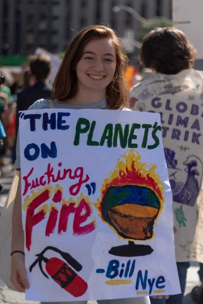 woman holding multicolored poster